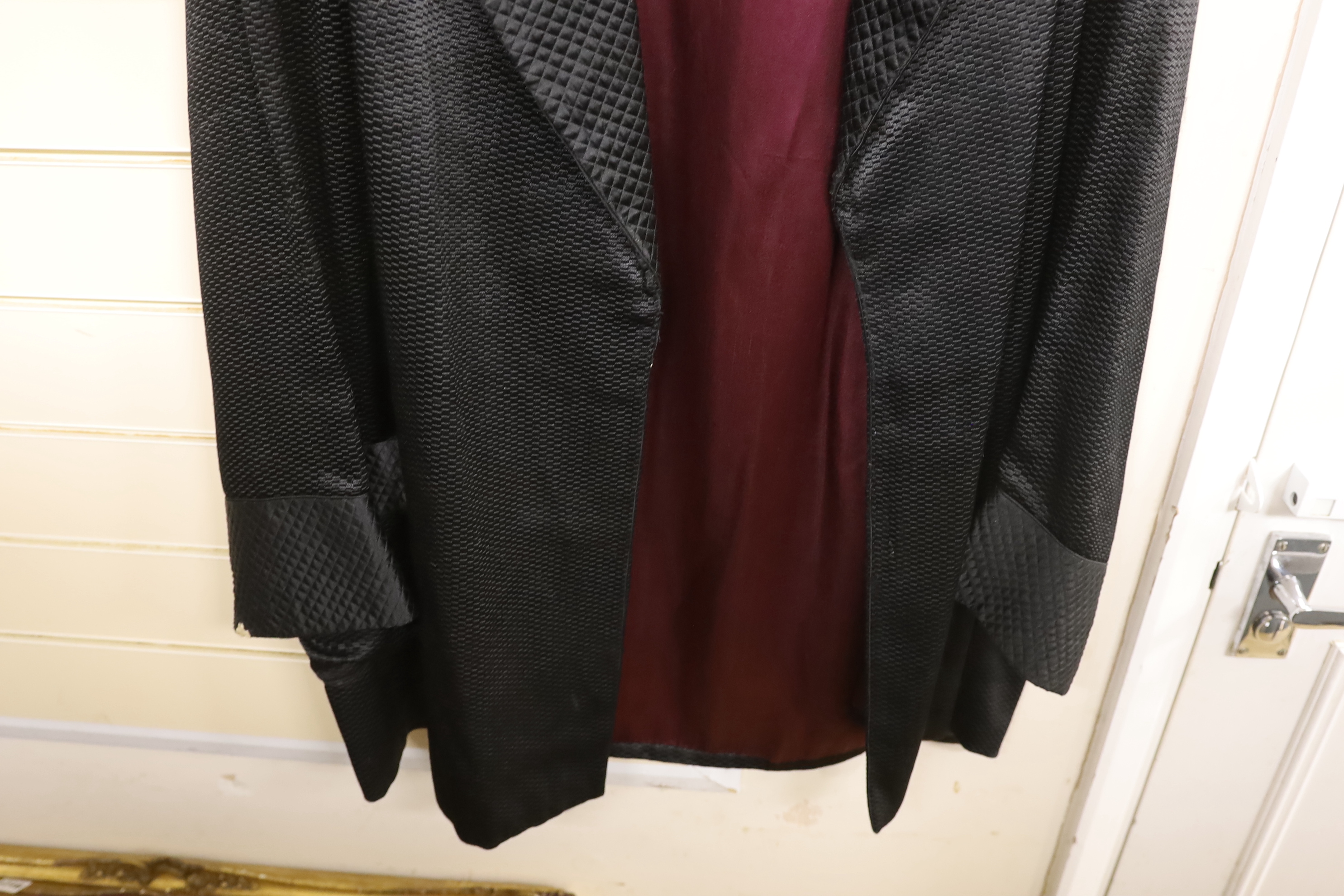 An Edwardian black silk gent smoking jacket